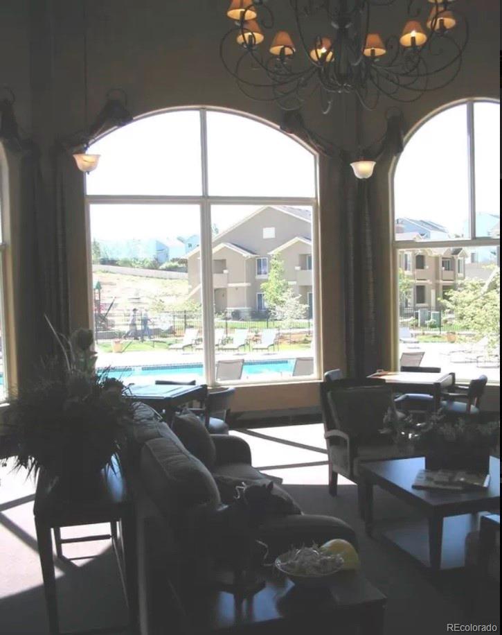 4730 Copeland Circle, Unit 101 Highlands Ranch, CO 80126 - Photo 13 of 14 a living room filled with furniture and a large window