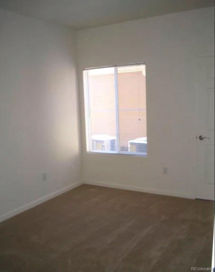 4730 Copeland Circle, Unit 101 Highlands Ranch, CO 80126 - Photo 4 of 14 an empty room with a window