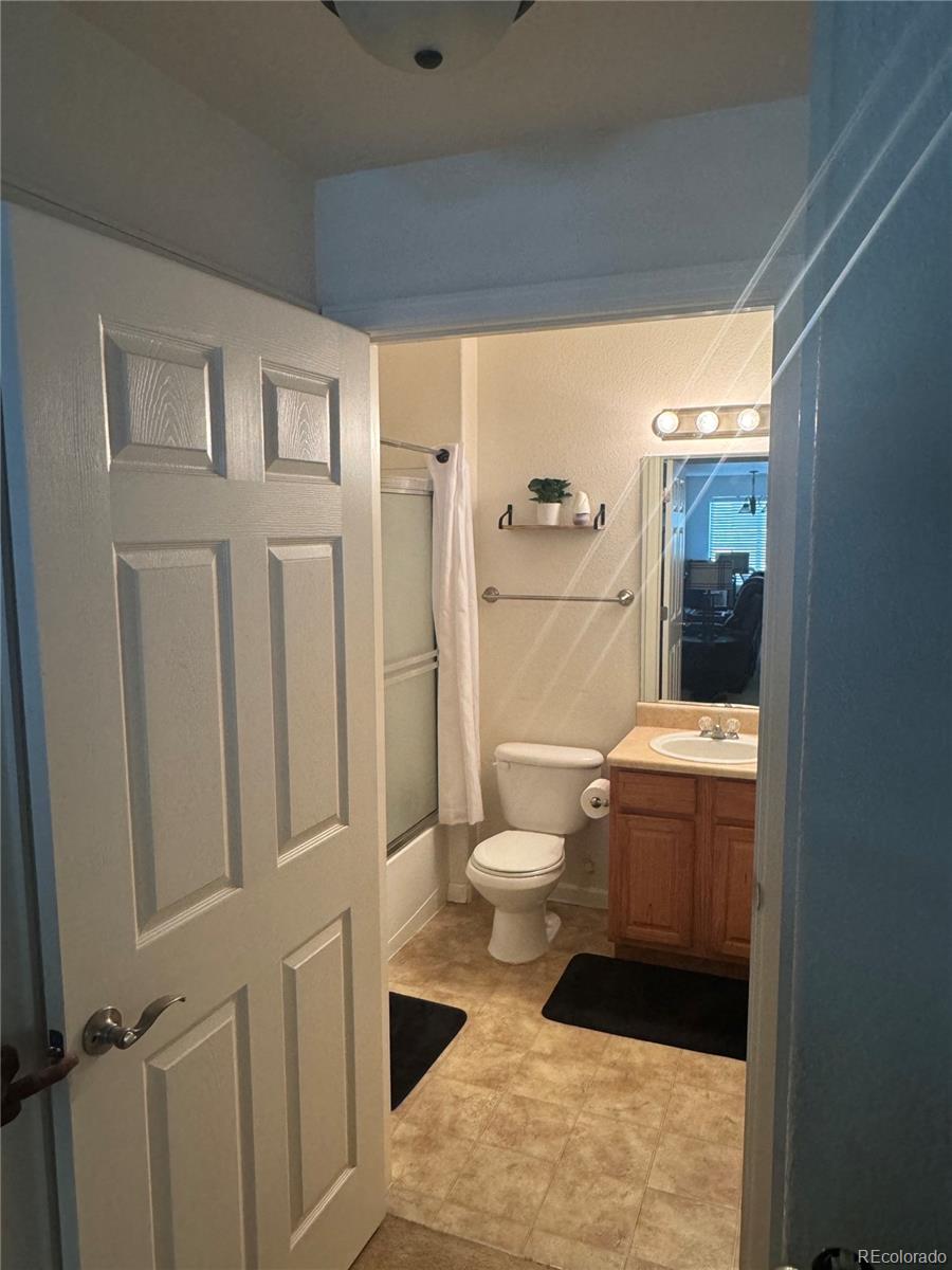 4730 Copeland Circle, Unit 101 Highlands Ranch, CO 80126 - Photo 8 of 14 a bathroom with a toilet a sink and shower