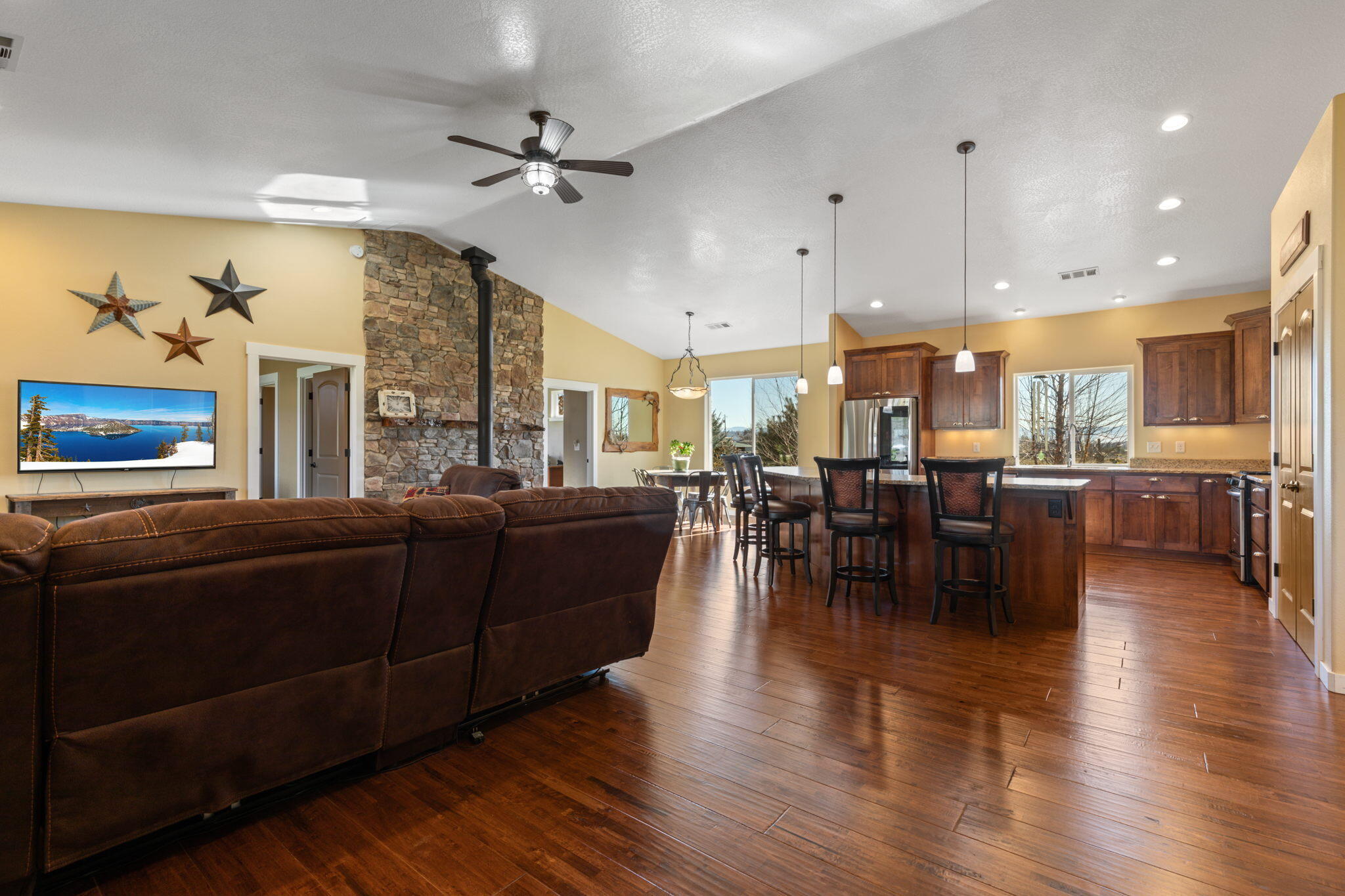 3923 Beagle Road White City, OR 97503 - Photo 4 of 31 a living room with couches a table and chairs with wooden floor