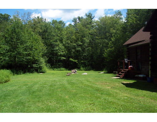 191 Hartland Road Tolland, MA 01034 - Photo 12 of 24 a backyard of a house with lots of green space