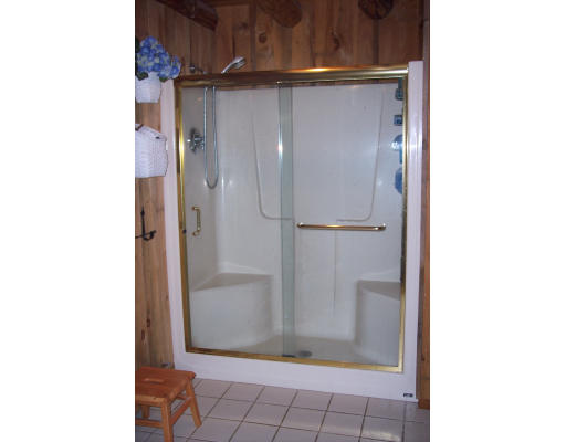 191 Hartland Road Tolland, MA 01034 - Photo 23 of 24 a bathroom with a glass shower door