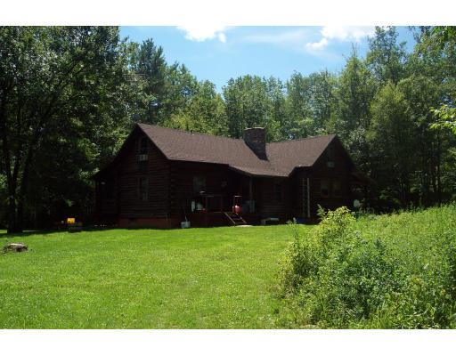 191 Hartland Road Tolland, MA 01034 - Photo 5 of 24 a house that has a big yard