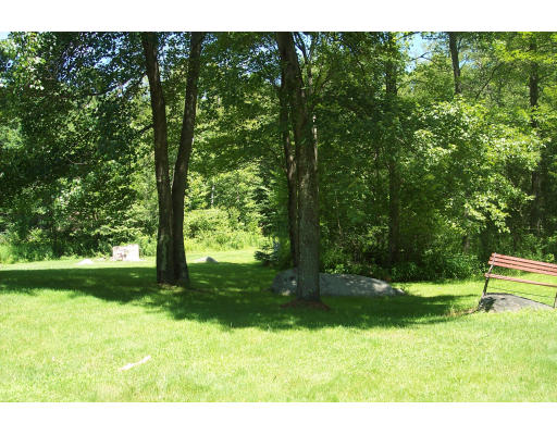 191 Hartland Road Tolland, MA 01034 - Photo 7 of 24 a backyard of a house with a yard and outdoor seating