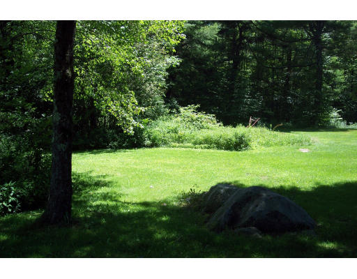 191 Hartland Road Tolland, MA 01034 - Photo 8 of 24 a view of a grassy field with trees