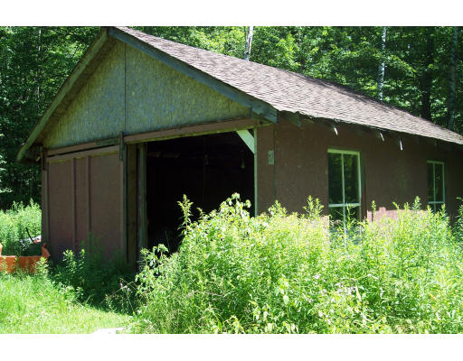 191 Hartland Road Tolland, MA 01034 - Photo 10 of 24 a front view of a house with garden