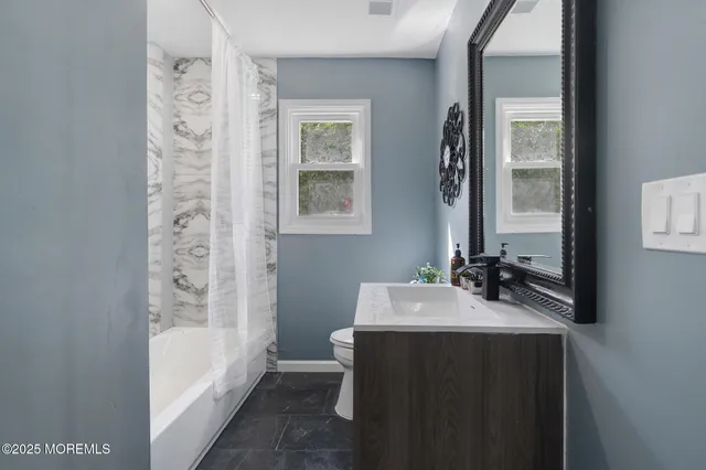 a bathroom with a sink a bathtub and a mirror