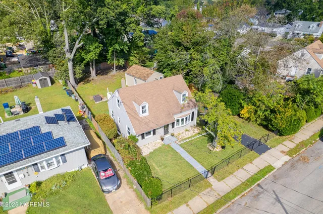 an aerial view of a house with a swimming pool
