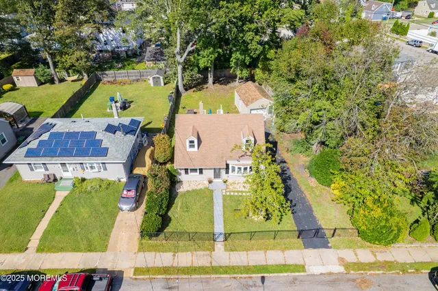 an aerial view of residential houses with outdoor space and swimming pool