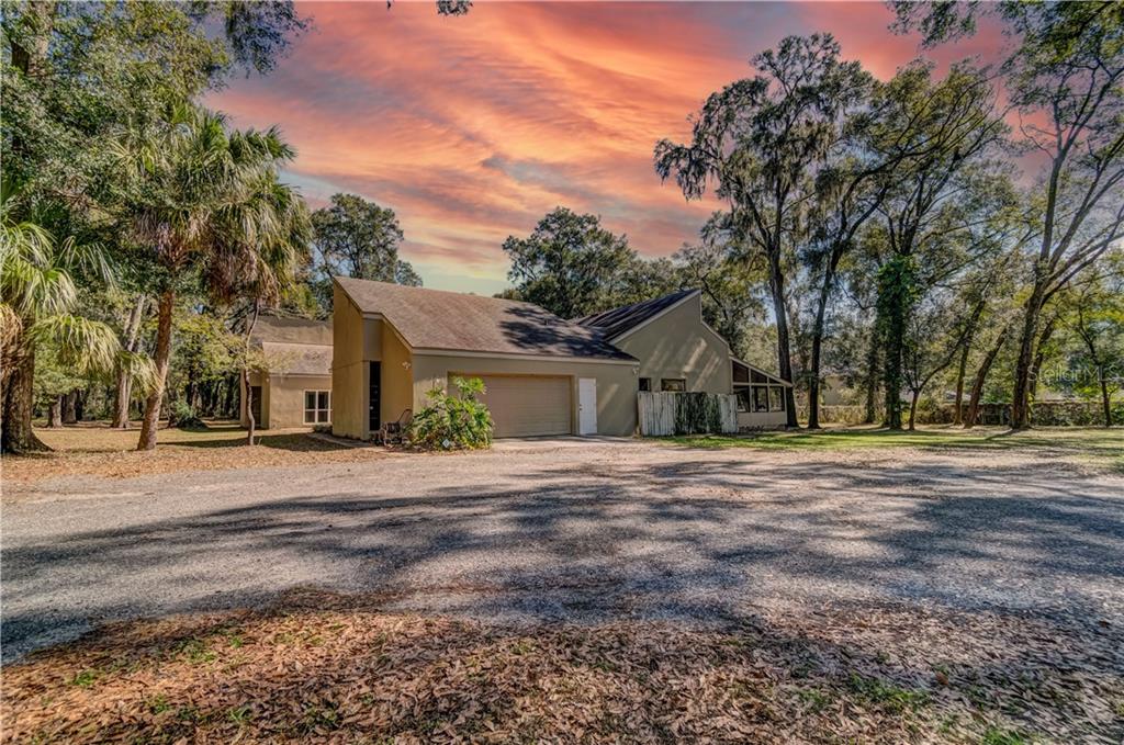 2810 Little Road Valrico, FL 33596 - Photo 1 of 1 a front view of a house with a yard and trees
