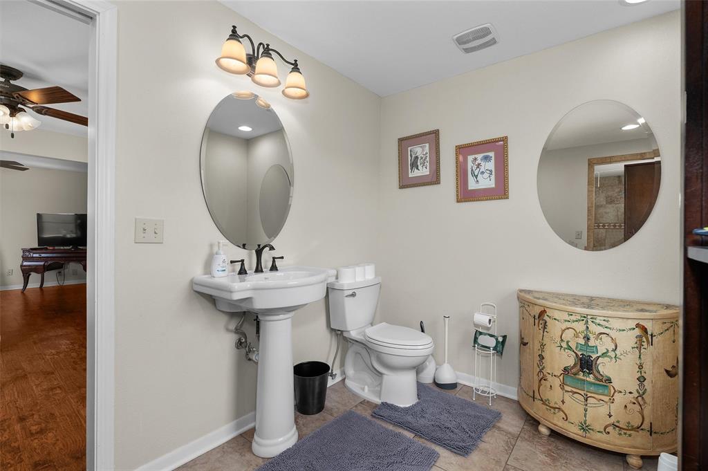 1131 Speights Road Keatchie, LA 71046 - Photo 24 of 33 Pedestal sink with dark-toned fixtures, oval wall mirror, and neutral wall paint