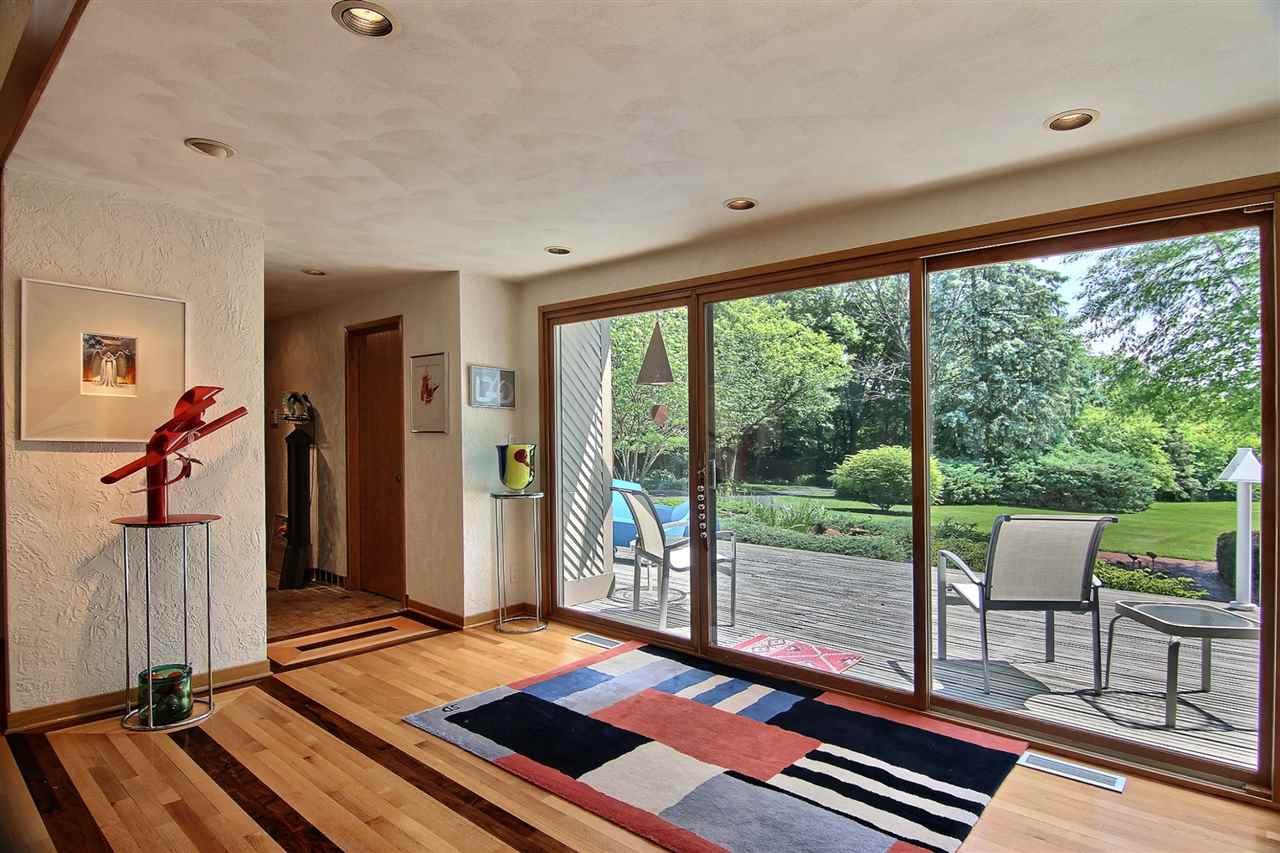 600 Riverside Road Belvidere, IL 61008 - Photo 3 of 25 a living room with a floor to ceiling window and a table