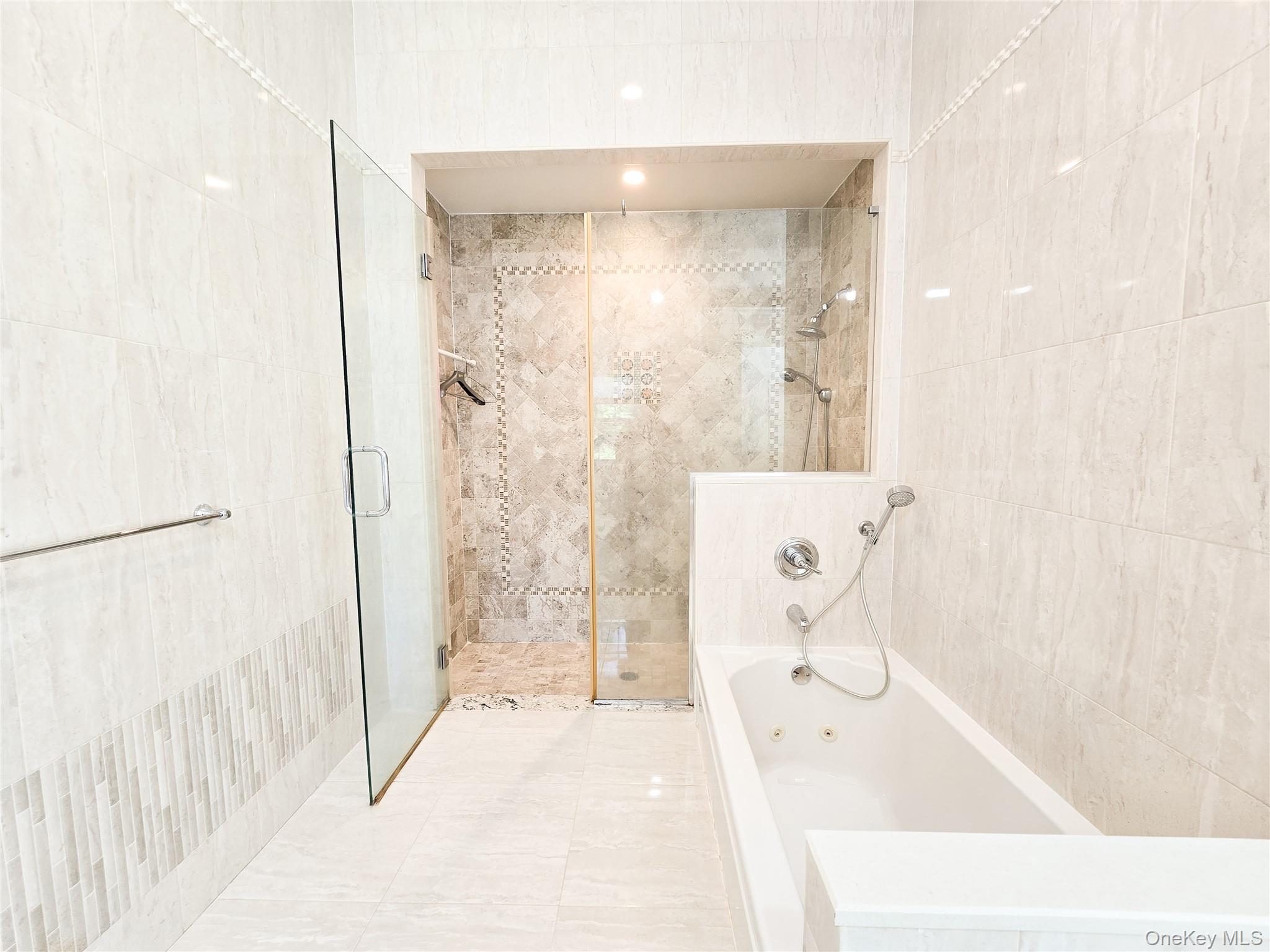 249 Cold Spring Road Syosset, NY 11791 - Photo 17 of 28 a bathroom with a bathtub and shower
