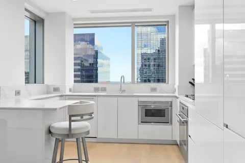 a spacious kitchen with a sink and a stove top oven