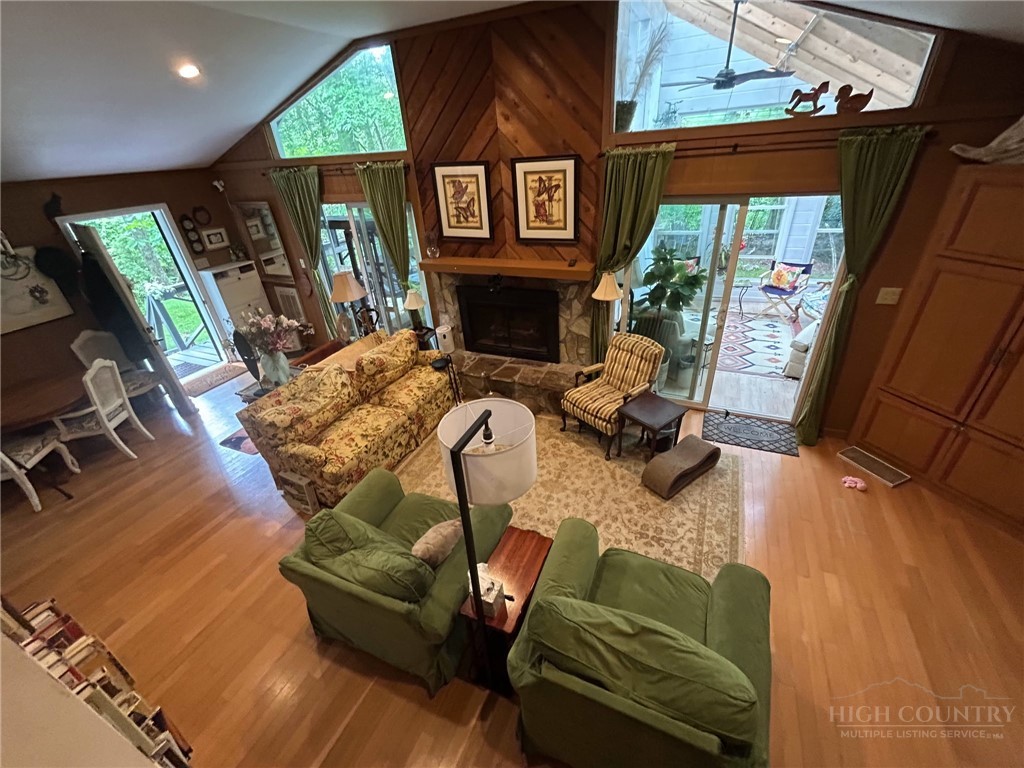 111 Locust Ridge Road Beech Mountain, NC 28604 - Photo 4 of 28 a living room with furniture a fireplace and a flat screen tv