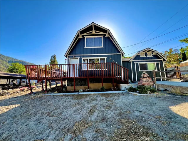 a view of a house with a yard and sitting area