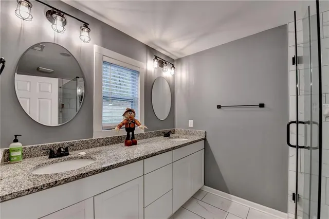 a bathroom with a double vanity sink and a mirror
