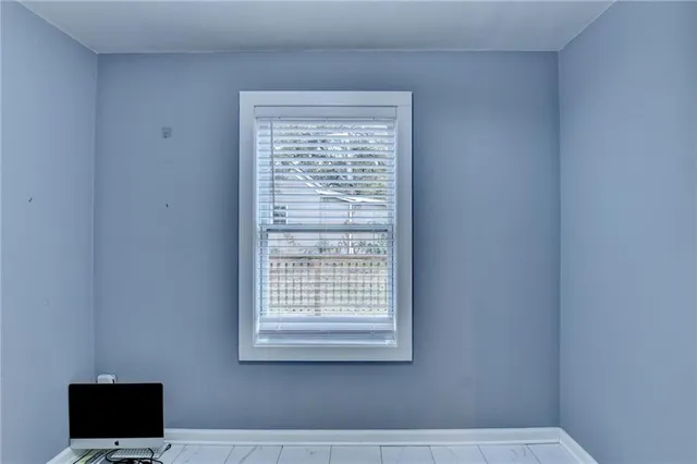 a bathroom with a window and a rug