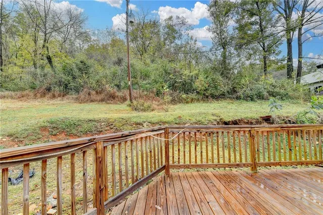 a view of balcony with wooden floor and fence