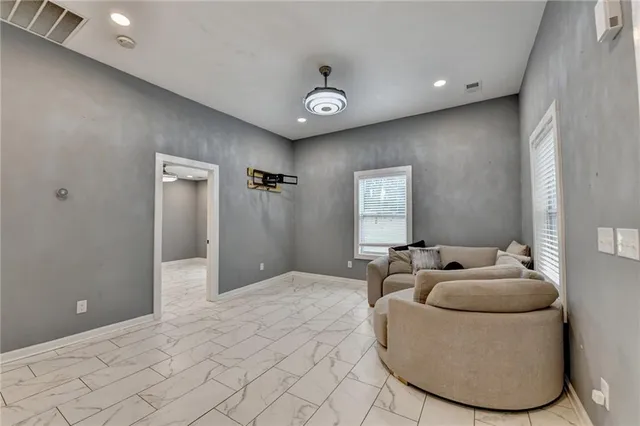 a large kitchen with granite countertop white cabinets and white appliances