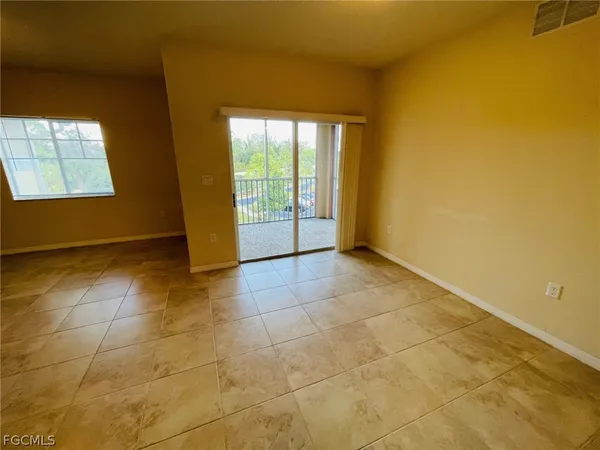 a view of an empty room and a window