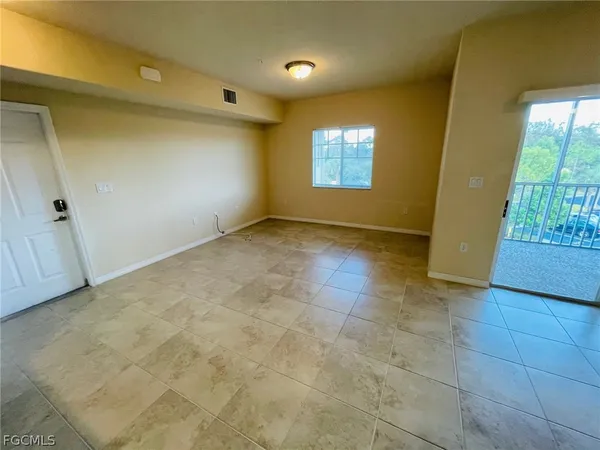 a view of kitchen with kitchen island and stainless steel appliances