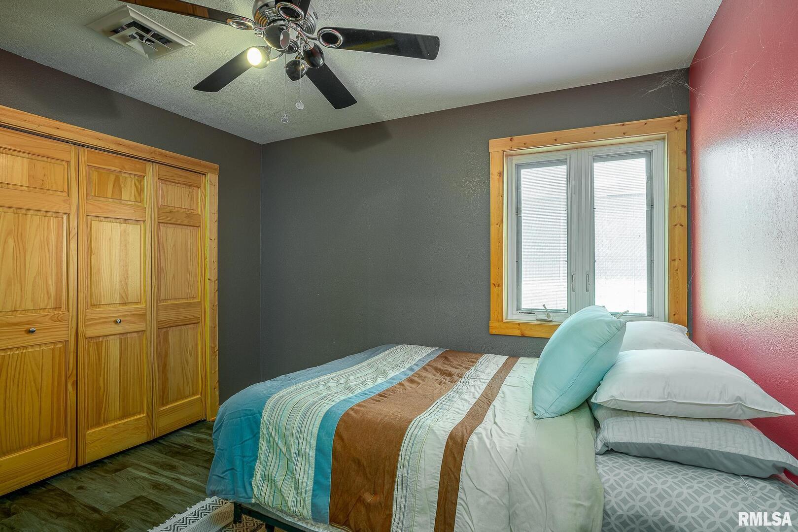 1012 Viaduct Road Savanna, IL 61074 - Photo 13 of 29 a bedroom with a bed and wooden floor