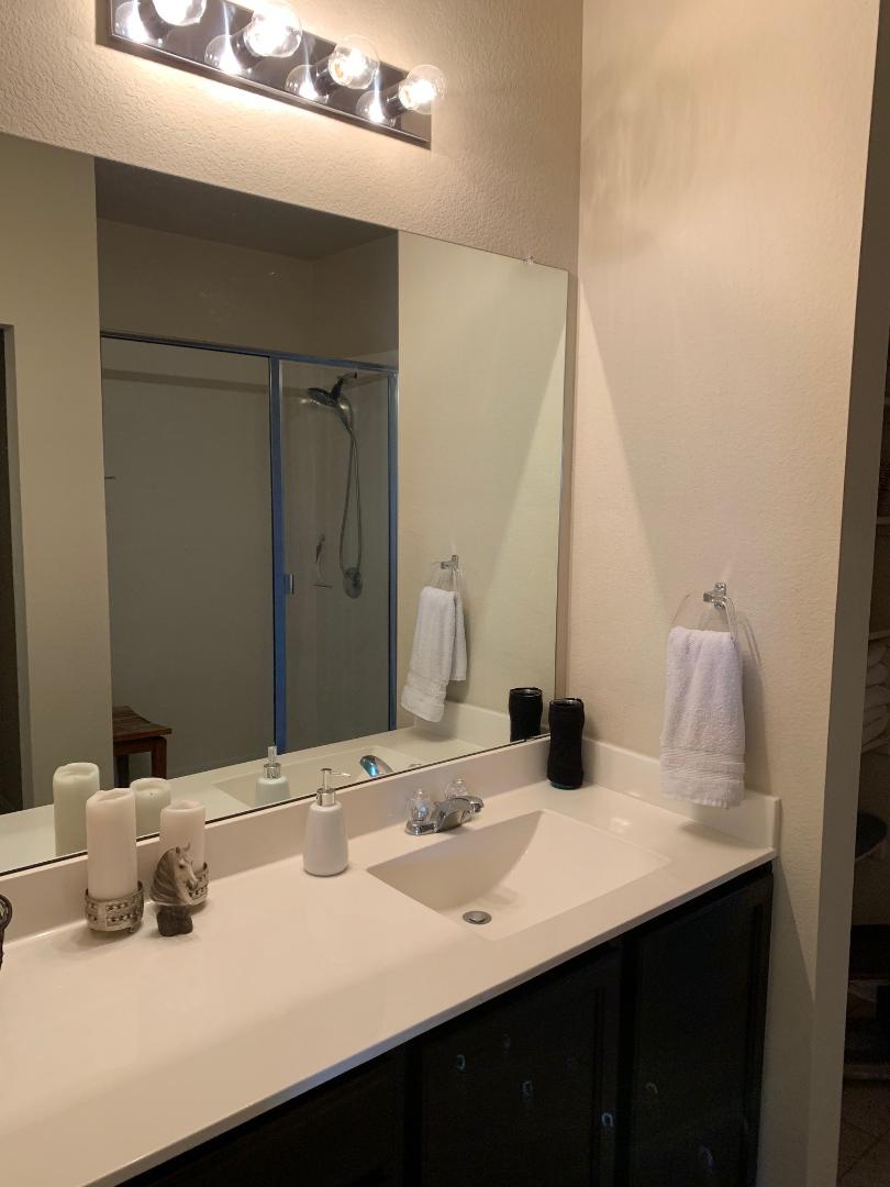 2020 Mottey Street Georgetown, TX 78626 - Photo 10 of 24 Bathroom with vanity, a shower stall, and a textured wall