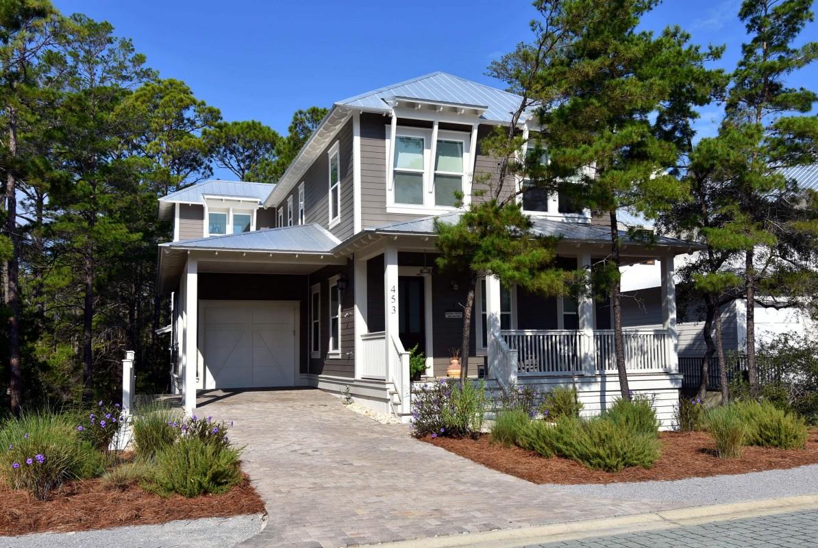 a front view of a house with garden