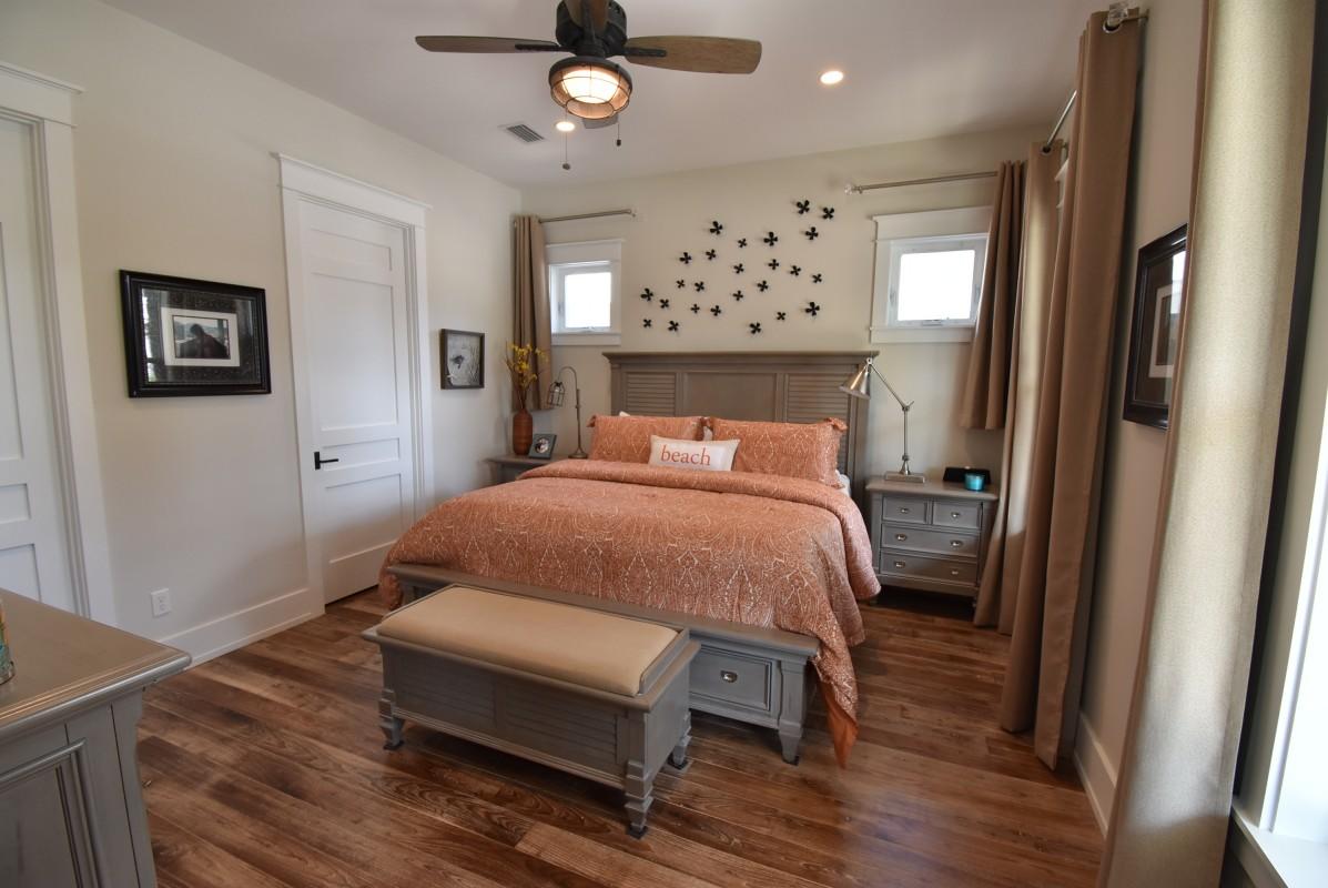 453 Matt's Way Santa Rosa Beach, FL 32459 - Photo 12 of 24 a bedroom with a bed and a chandelier