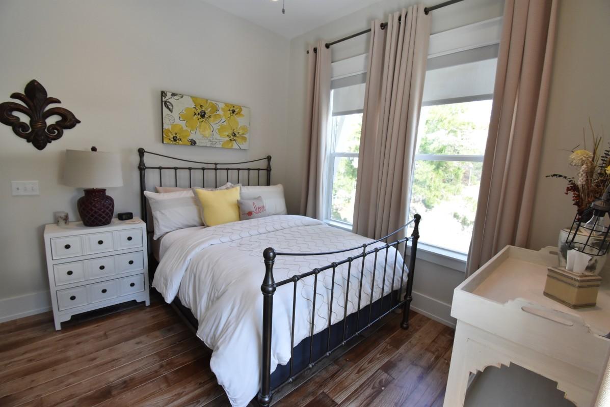 453 Matt's Way Santa Rosa Beach, FL 32459 - Photo 18 of 24 a bedroom with a bed and wooden floor