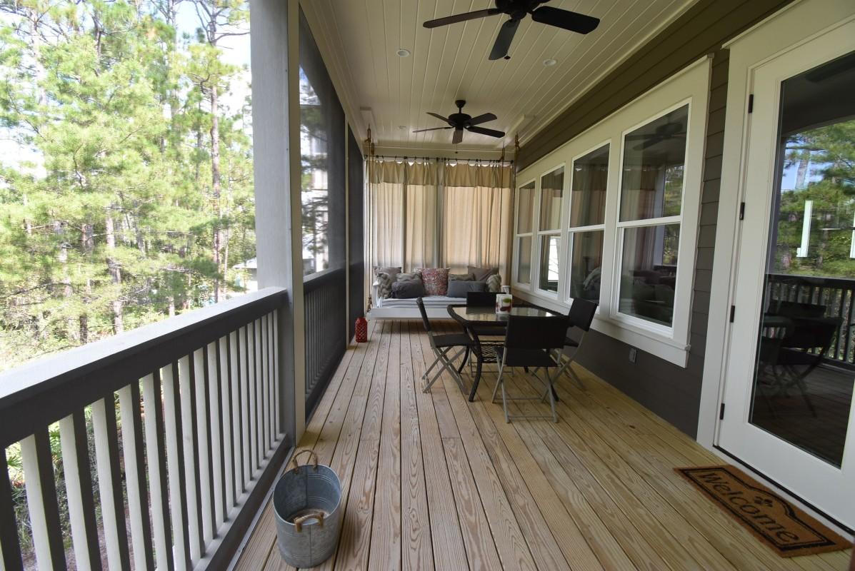 453 Matt's Way Santa Rosa Beach, FL 32459 - Photo 21 of 24 a balcony with wooden floor and outdoor seating
