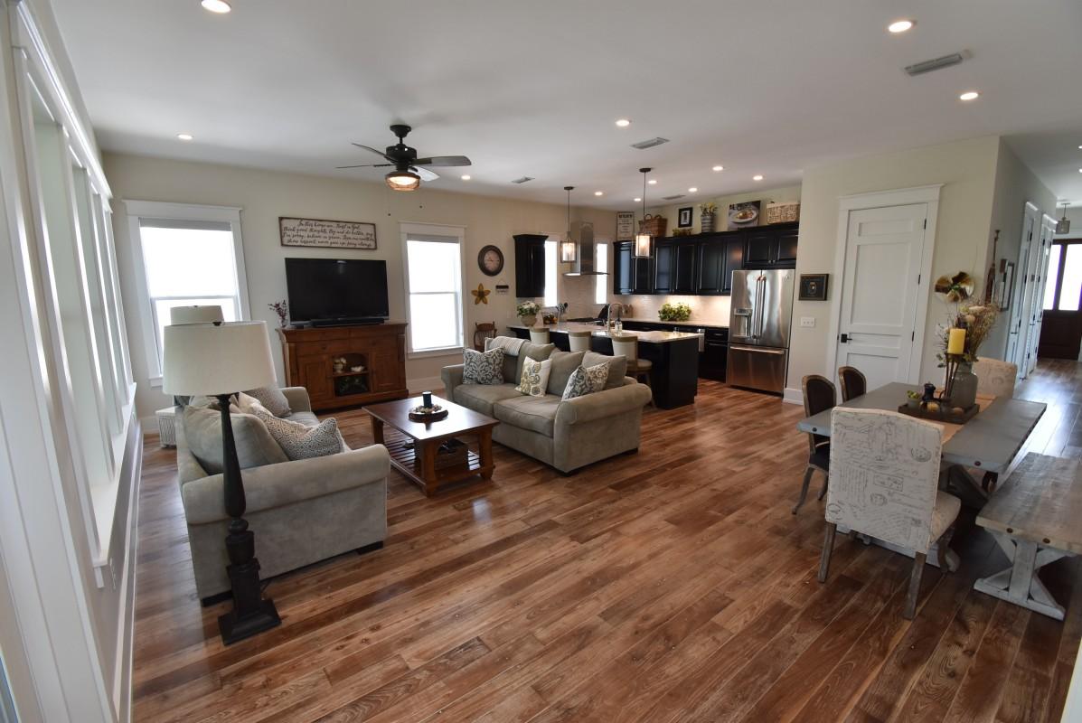 453 Matt's Way Santa Rosa Beach, FL 32459 - Photo 3 of 24 a living room with furniture a flat screen tv and a large window