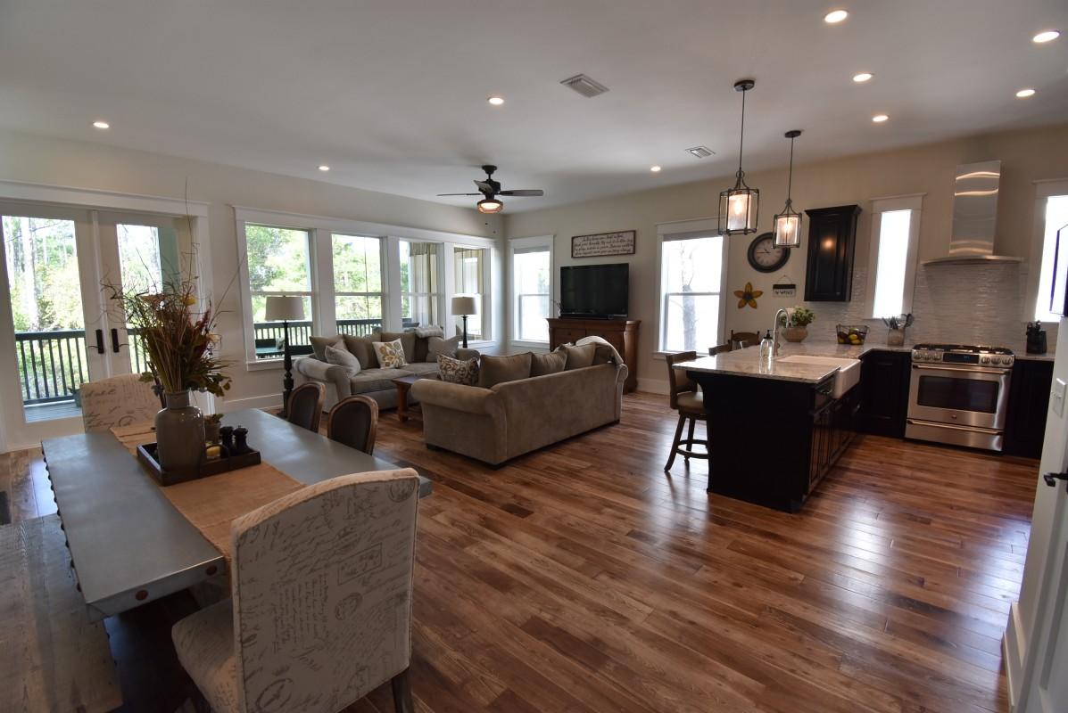 453 Matt's Way Santa Rosa Beach, FL 32459 - Photo 4 of 24 a living room with furniture kitchen area and a wooden floor