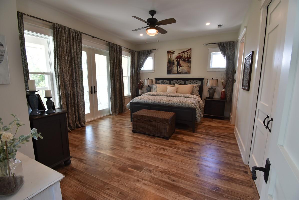 453 Matt's Way Santa Rosa Beach, FL 32459 - Photo 9 of 24 a spacious bedroom with a bed and a chandelier