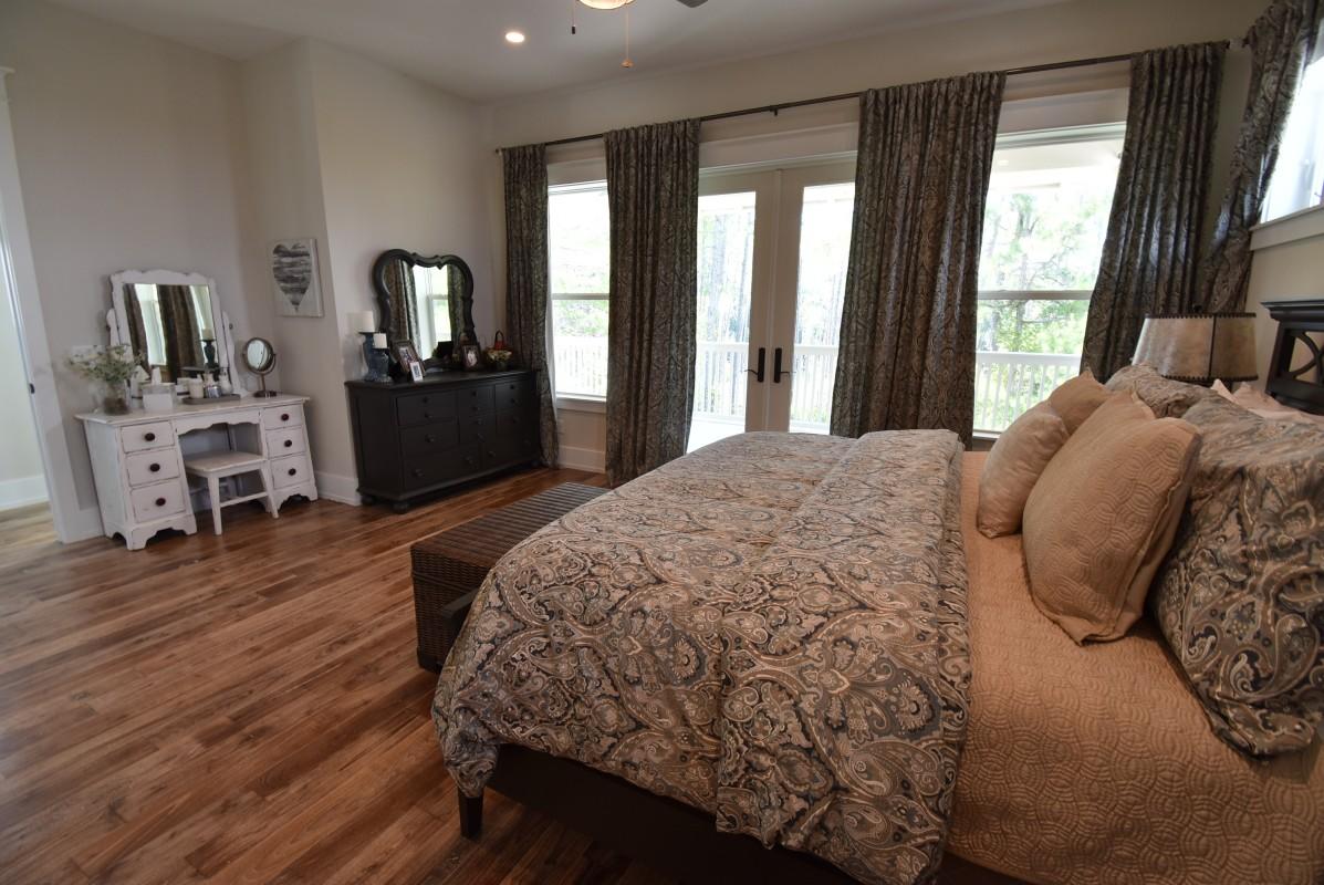 453 Matt's Way Santa Rosa Beach, FL 32459 - Photo 10 of 24 a spacious bedroom with a bed and wooden floor