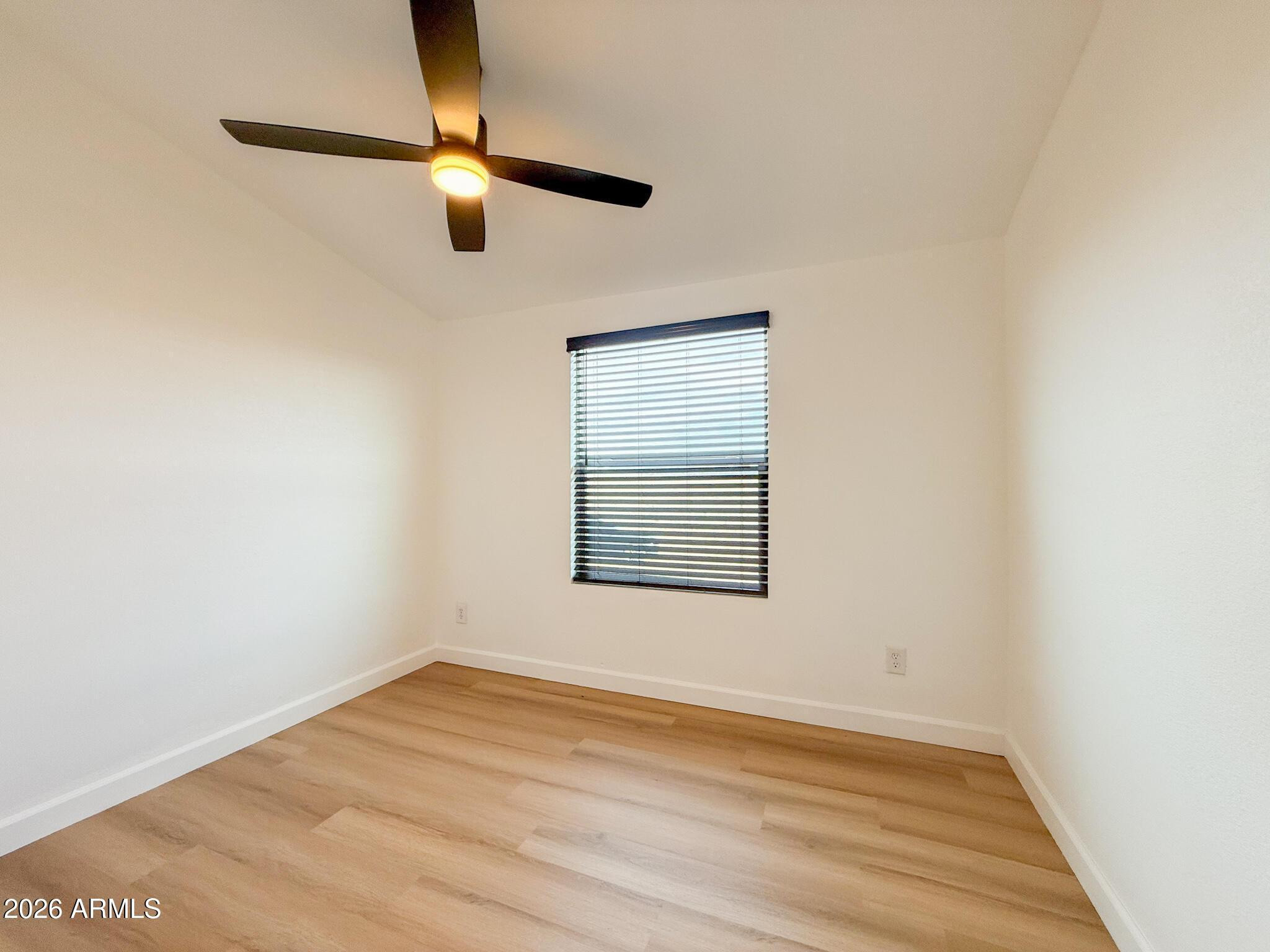 51880 North Gold Plains Road Seligman, AZ 86337 - Photo 15 of 24 a view of an empty room with wooden floor and a window
