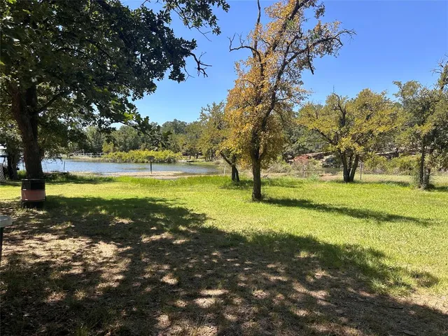 a view of yard with swimming pool and trees