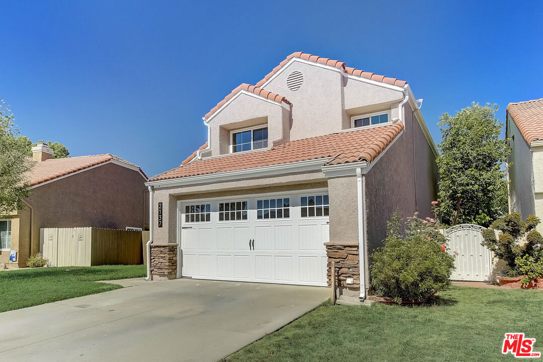 2137 Crosscreek Avenue Simi Valley, CA 93063 - Photo 11 of 31 a front view of a house with a garden