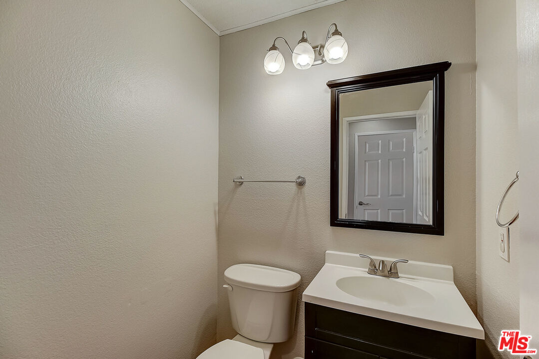 2137 Crosscreek Avenue Simi Valley, CA 93063 - Photo 18 of 31 a bathroom with a toilet a sink and mirror