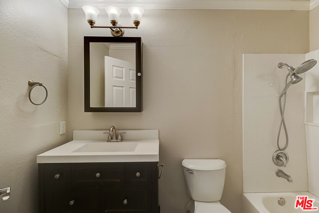 2137 Crosscreek Avenue Simi Valley, CA 93063 - Photo 23 of 31 a bathroom with a granite countertop sink toilet and shower