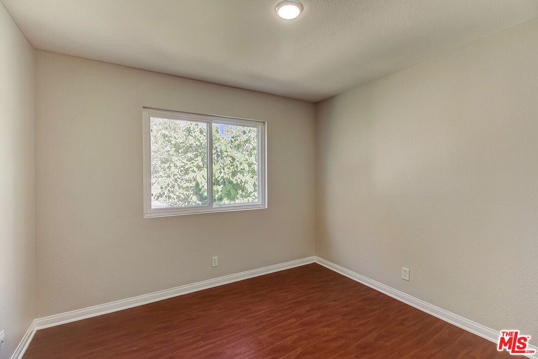 2137 Crosscreek Avenue Simi Valley, CA 93063 - Photo 25 of 31 an empty room with wooden floor and windows