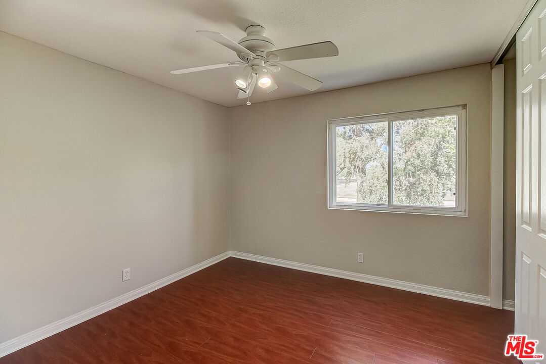 2137 Crosscreek Avenue Simi Valley, CA 93063 - Photo 26 of 31 an empty room with wooden floor and windows