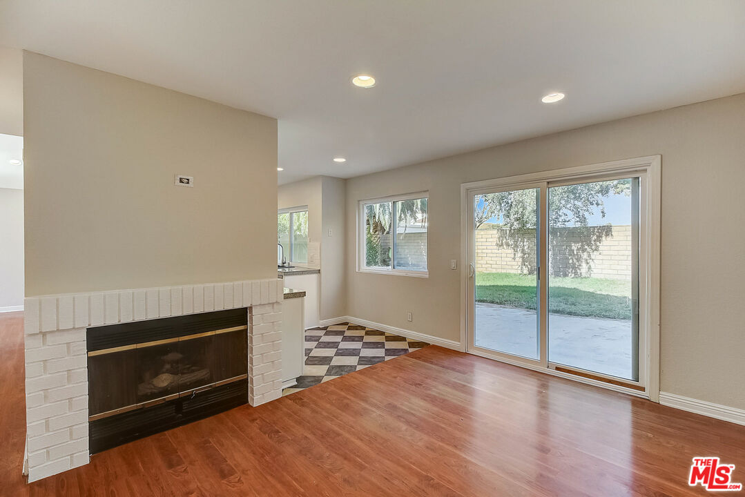 2137 Crosscreek Avenue Simi Valley, CA 93063 - Photo 6 of 31 a view of an empty room with a fireplace and a window