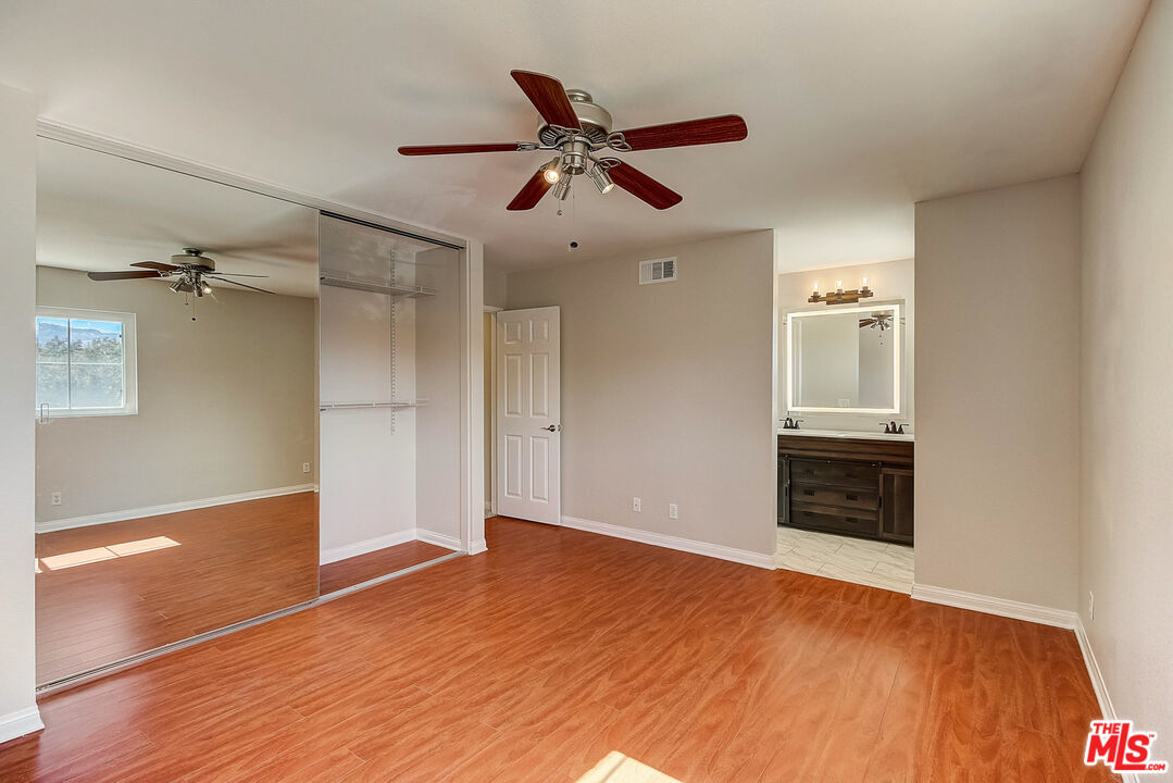 2137 Crosscreek Avenue Simi Valley, CA 93063 - Photo 7 of 31 a view of empty room with wooden floor and ceiling fan