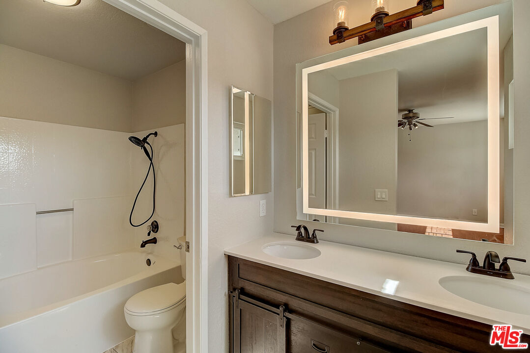 2137 Crosscreek Avenue Simi Valley, CA 93063 - Photo 8 of 31 a bathroom with a granite countertop sink a toilet and shower