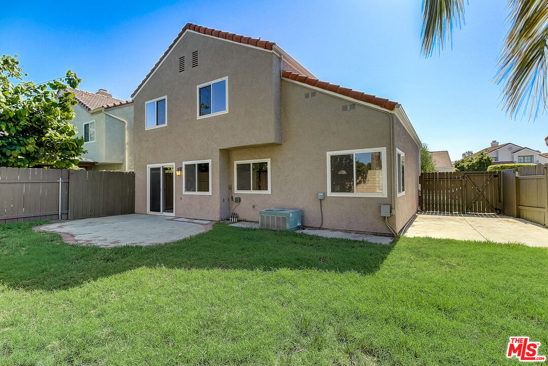 2137 Crosscreek Avenue Simi Valley, CA 93063 - Photo 9 of 31 a front view of a house with a yard and garage