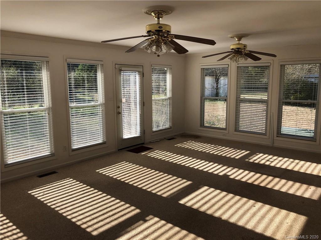 4701 Old Hickory Road Lancaster, SC 29720 - Photo 14 of 24 a bedroom with wooden floor a chandelier and windows