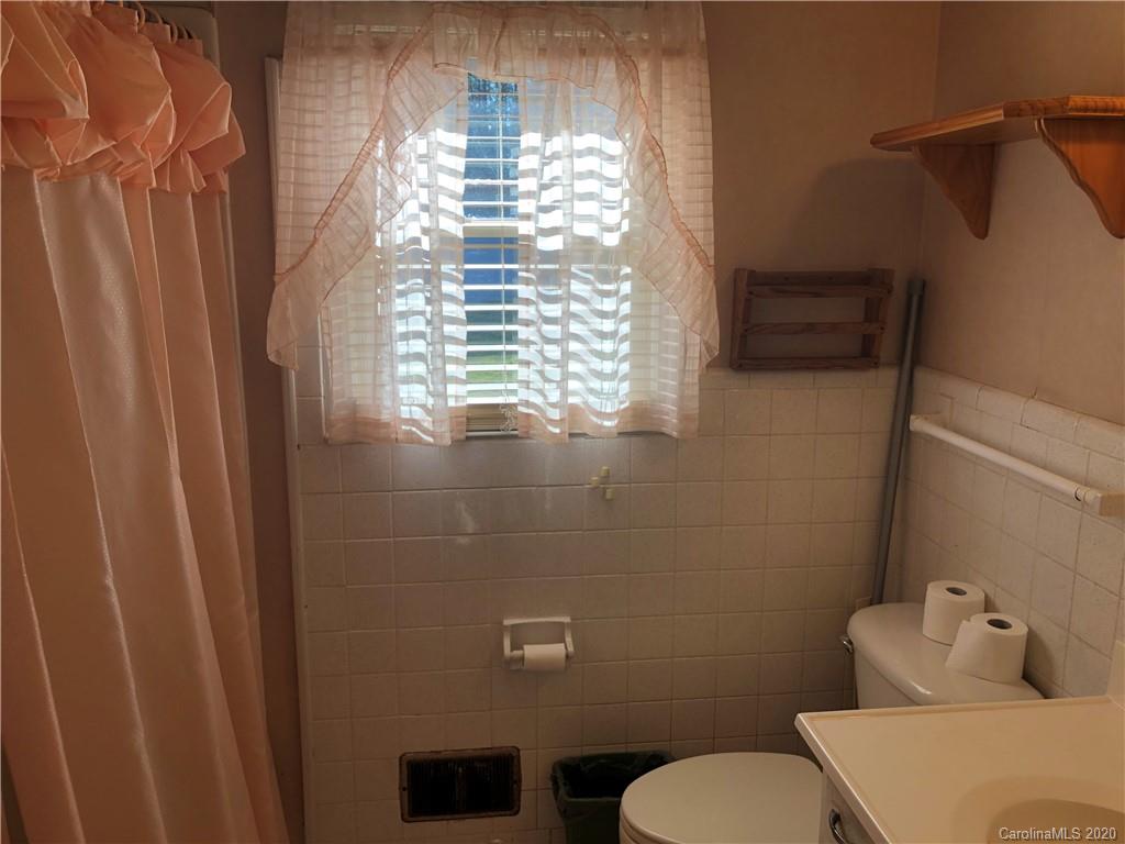 4701 Old Hickory Road Lancaster, SC 29720 - Photo 9 of 24 a bathroom with a toilet and a shower curtain