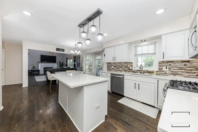 a kitchen with a sink stove and cabinets